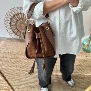Bolso bucket combinado serraje y piel marrón pompón iniciales bordadas