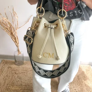 Bombonera piel beige arandelas doradas iniciales bordadas